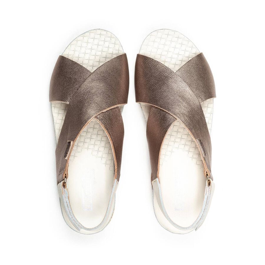 Beige metallic sandals top view with crossover straps and textured light lining