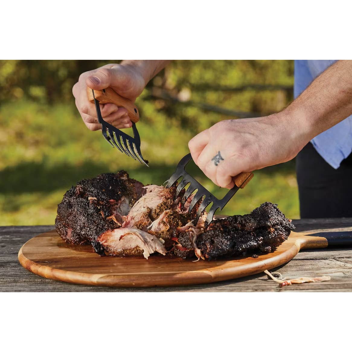 BBQ meat claws in use, grasping and lifting grilled meat