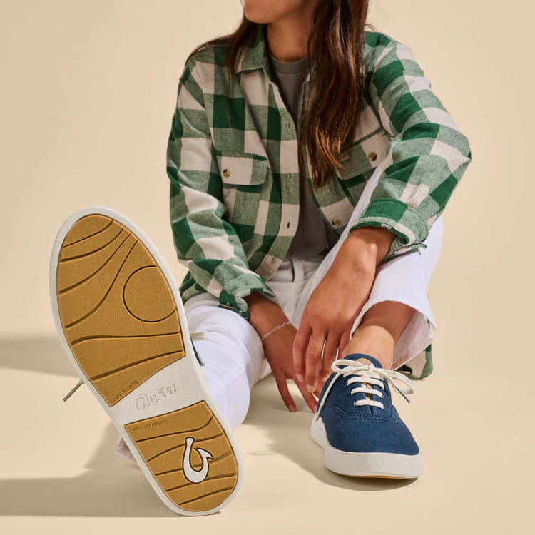 Navy canvas sneakers with white laces and cream sole, shown on model