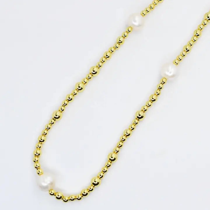 Gold chain necklace with small bead links and white pearl details