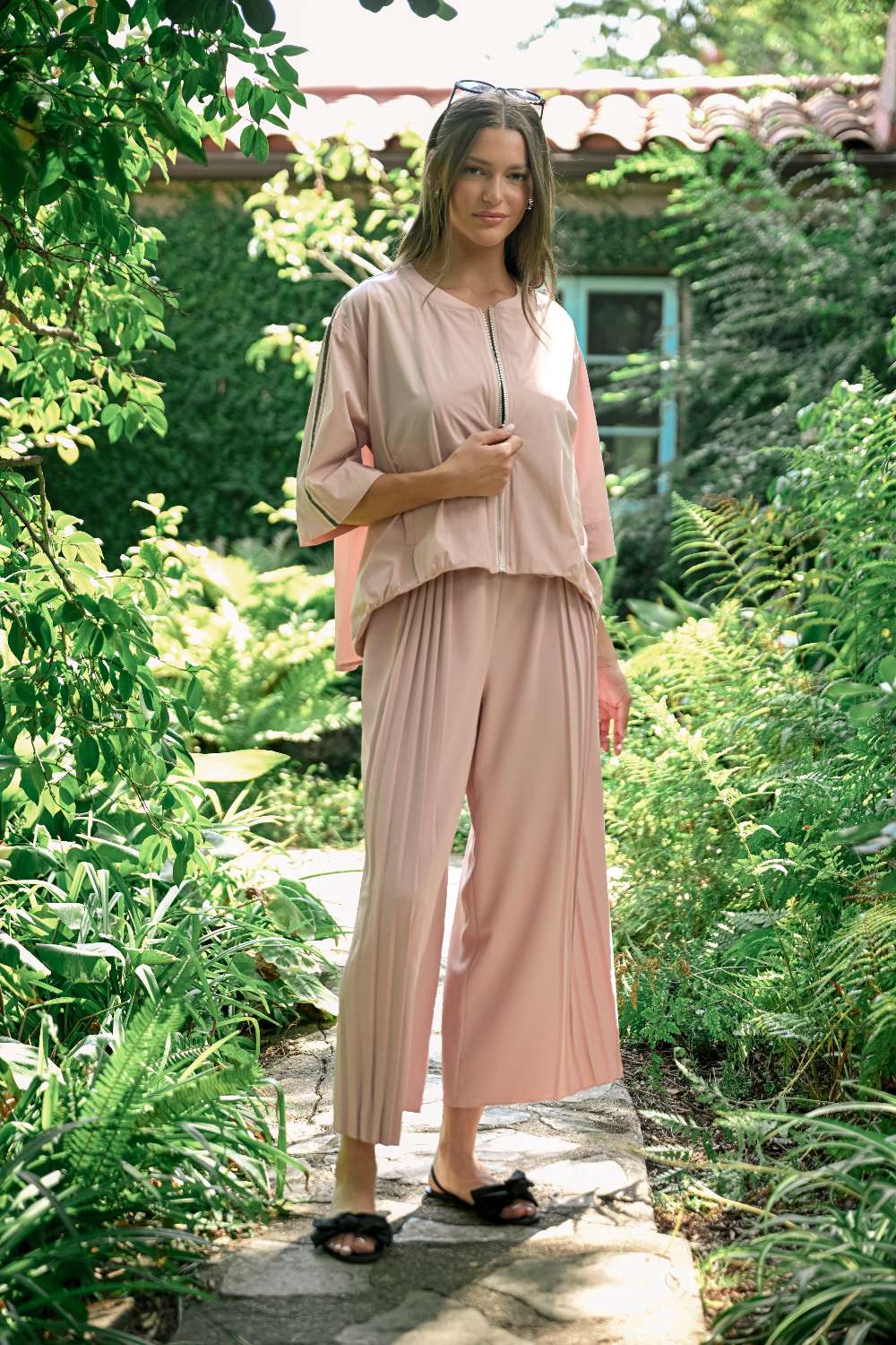 Jolie Top in blush woven parachute fabric with relaxed fit, wide sleeves, and front zipper closure