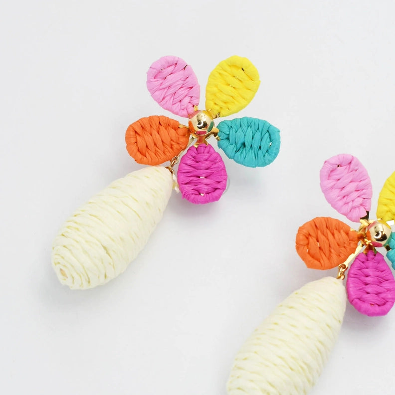 Close-up multicolor raffia flower earring with gold clasp and pink/yellow/orange/teal petals