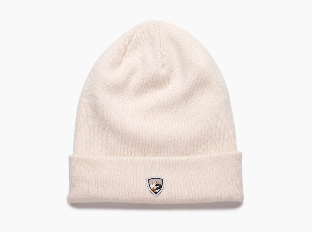 Merino Beanie in a soft seasalt color featuring a small embroidered shield emblem, crafted from premium wool for warmth and durable outdoor style.