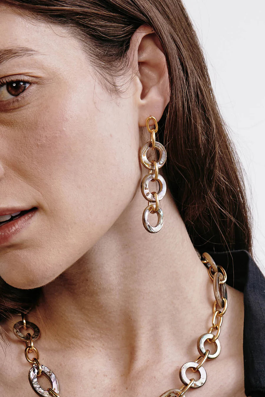 Mariner earrings worn: gold-tone chain with iridescent abalone disc dangles and rings