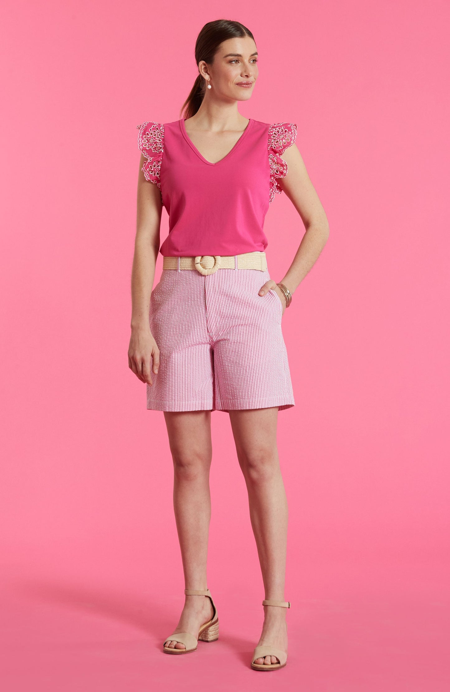 Woman wearing Bev Seersucker Bermuda Short styled with feminine pink top and neutral sandals, Tyler Boe