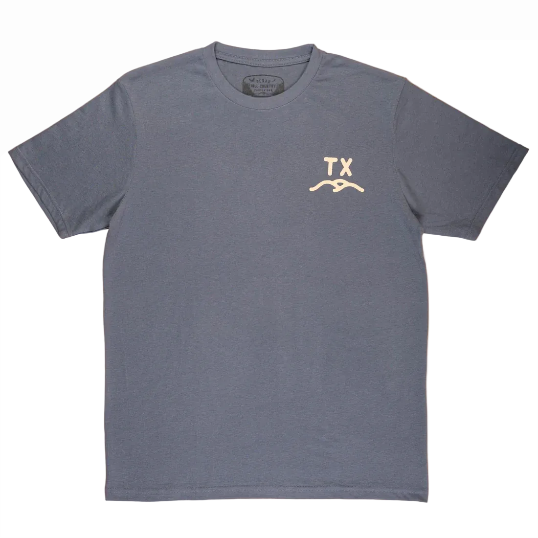 All'S Good Tee in muted blue-gray with a small cream TX logo and wave graphic on chest, made from high-quality, durable fabric for effortless Hill Country style.