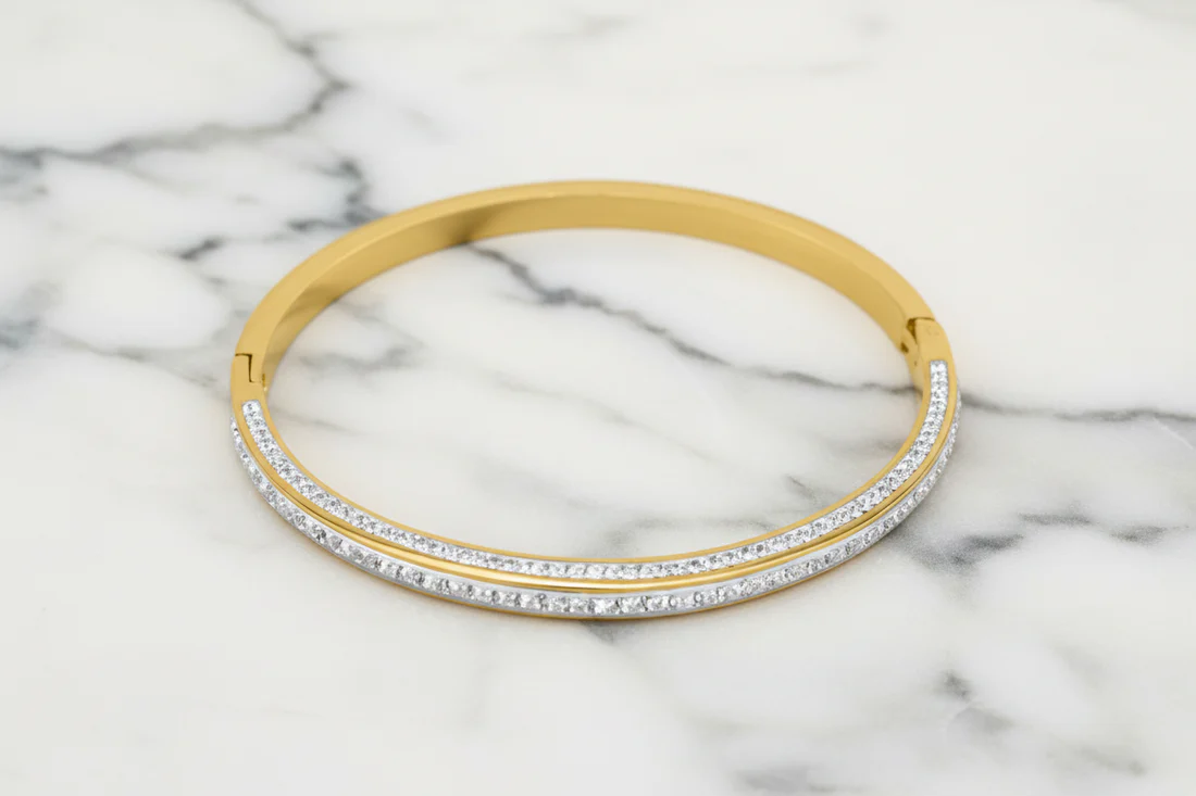 Steel Gold Pave Bangle featuring two rows of clear stones set in a gold finish, elegant lifestyle accessory personally curated in Fredericksburg, Texas.