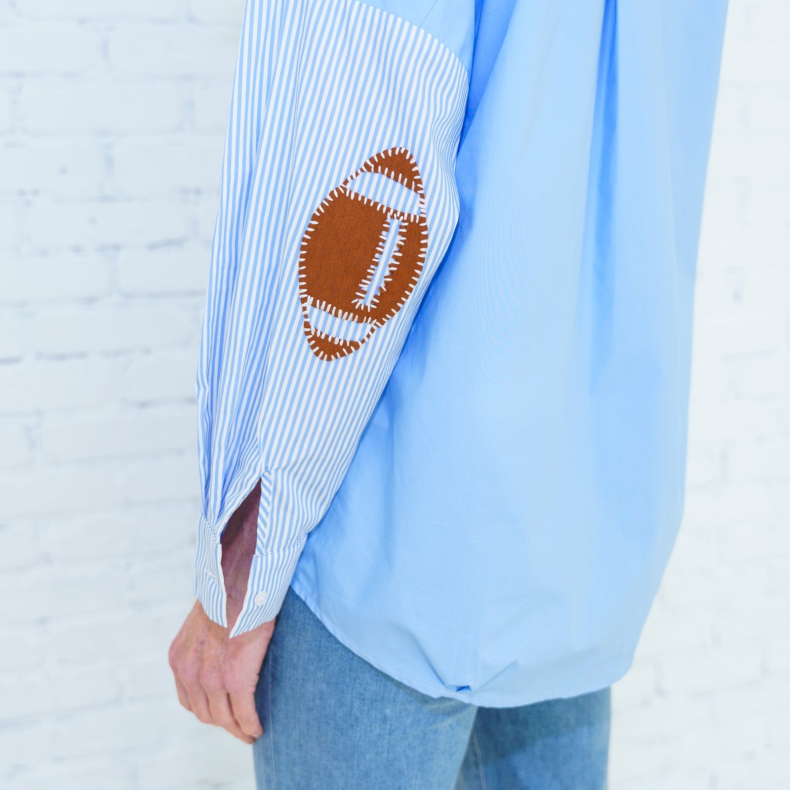 Preppy Football Shirt Powder Blue with striped sleeve and stitched football patch by CARYN LAWN