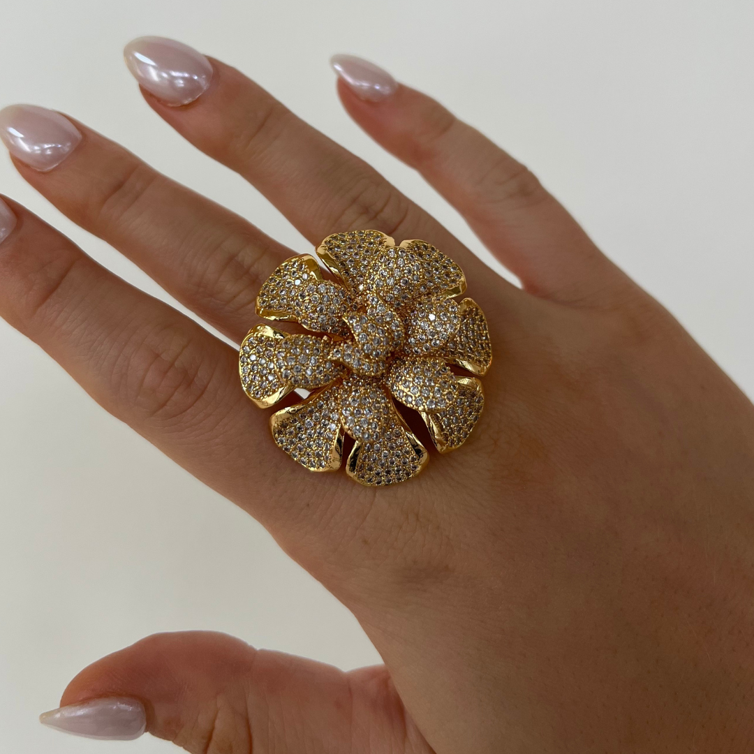 Blooming pavé flower ring, gold tone with glittering petal stones on finger