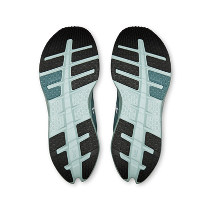 Pair of running shoe soles with black and pale blue traction patterns