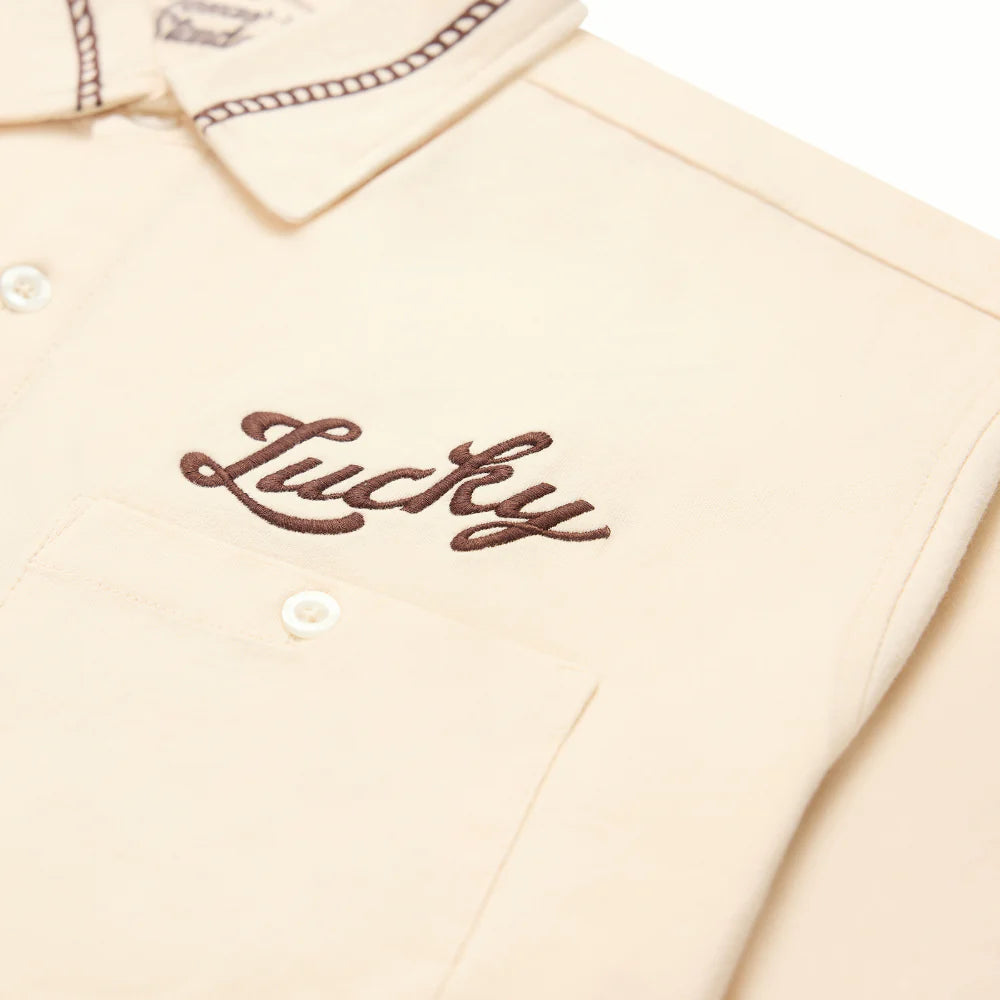 Drifter Shirt - Luck Is Earned beige short sleeve with brown embroidered "Lucky" script by TEXAS STANDARD