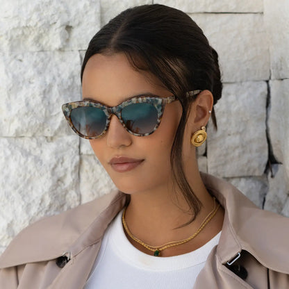Brown tortoiseshell cat-eye sunglasses with gray lenses, worn on face