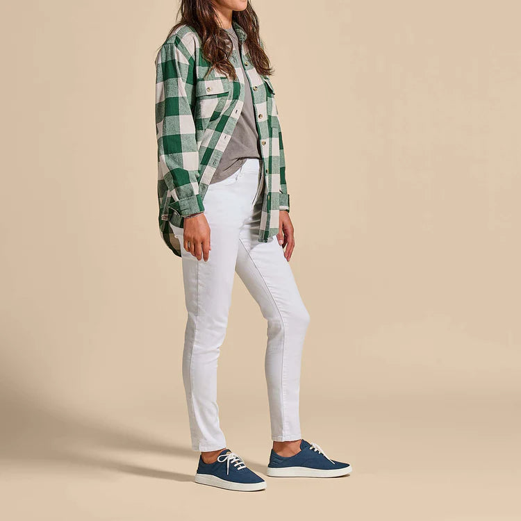 Model wearing navy lace-up sneakers with white laces and cream sole