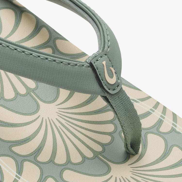 Close-up of green thong strap with stitching and patterned footbed