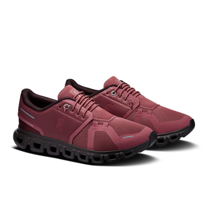Pair of burgundy lace-up athletic shoes with black soles