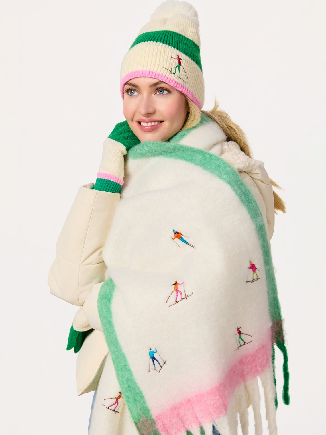 Woman wearing Alpine Scarf with embroidered skiers, styled with knit hat and gloves at HCO FBG