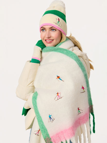Woman wearing Alpine Scarf with embroidered skiers, styled with knit hat and gloves at HCO FBG