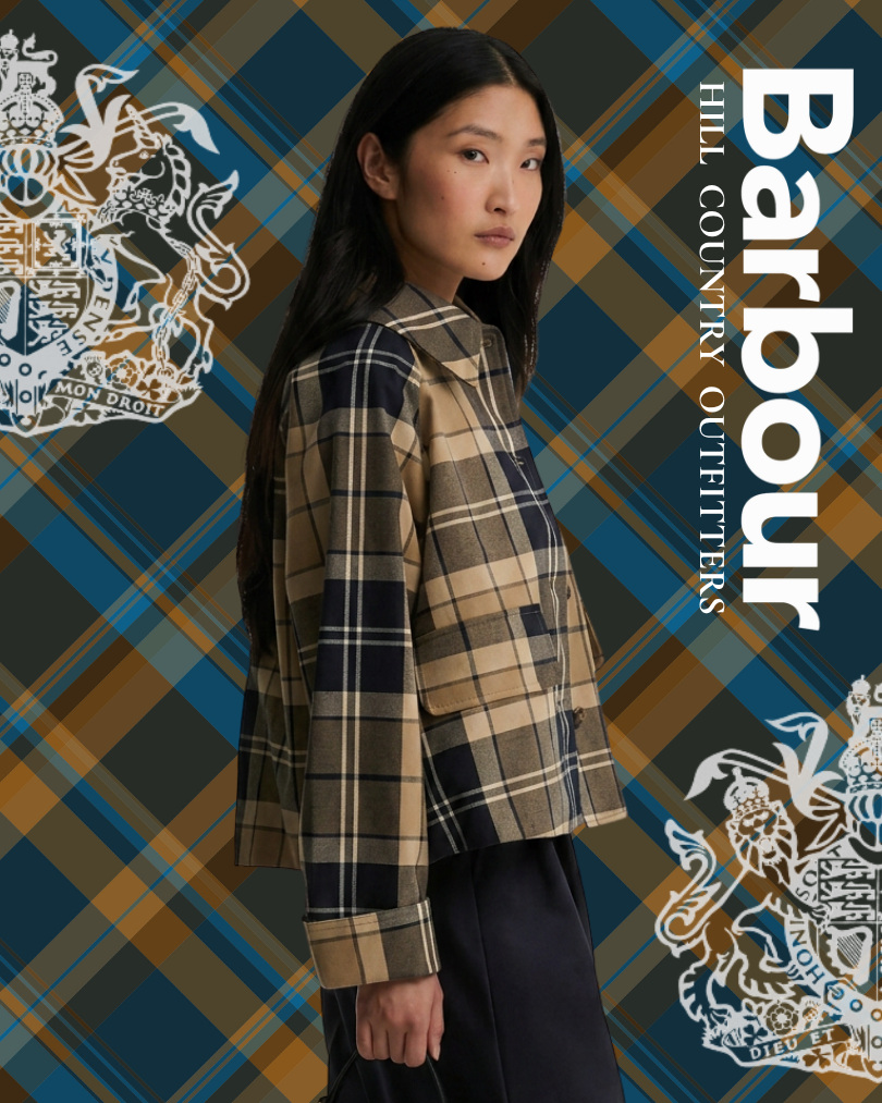 Woman wearing a plaid jacket against a Barbour tartan background