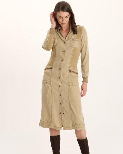 Woman wearing a beige dress with button details on a white background