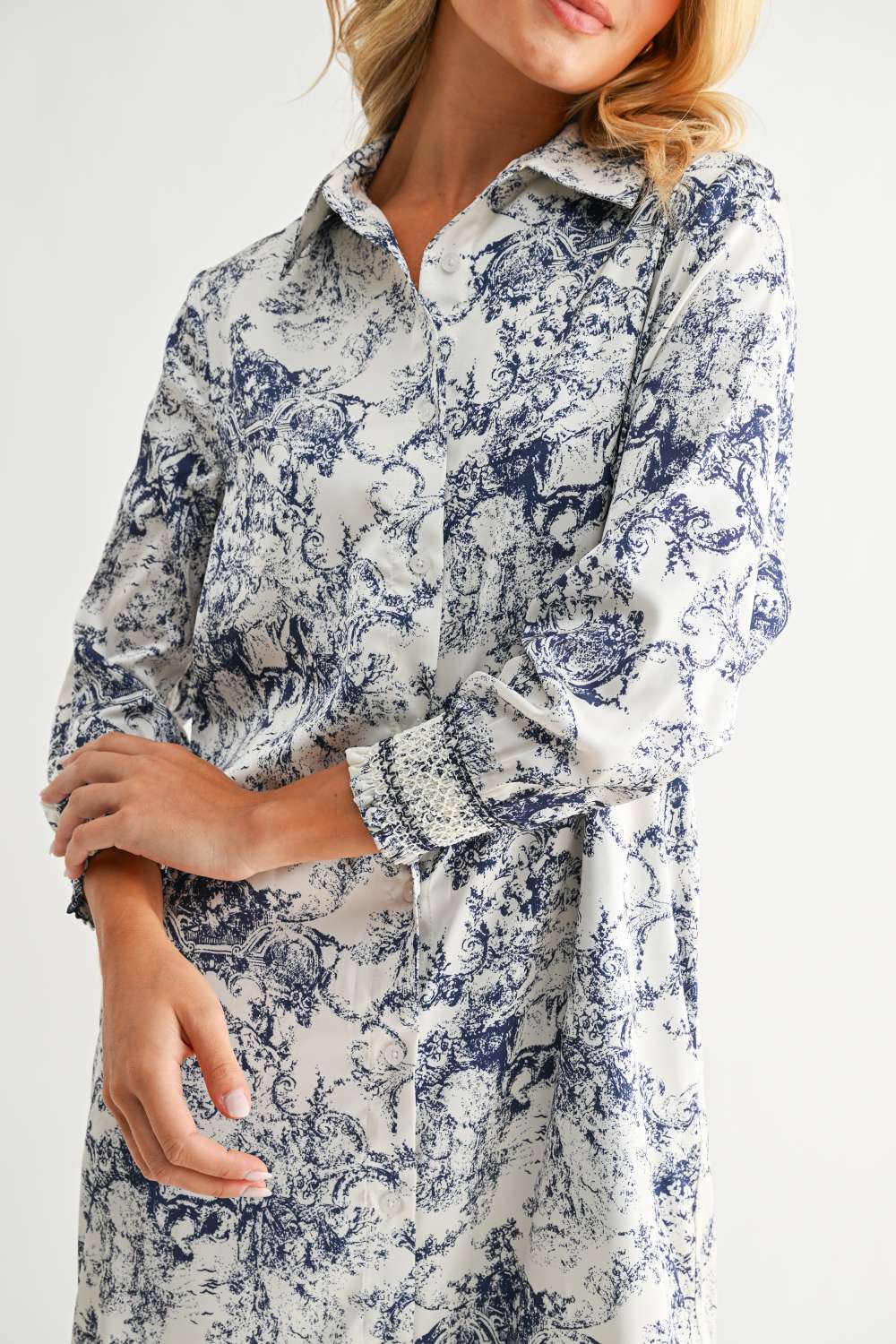Janett Dress in blue and white floral toile print with collared neckline and cuffed long sleeves