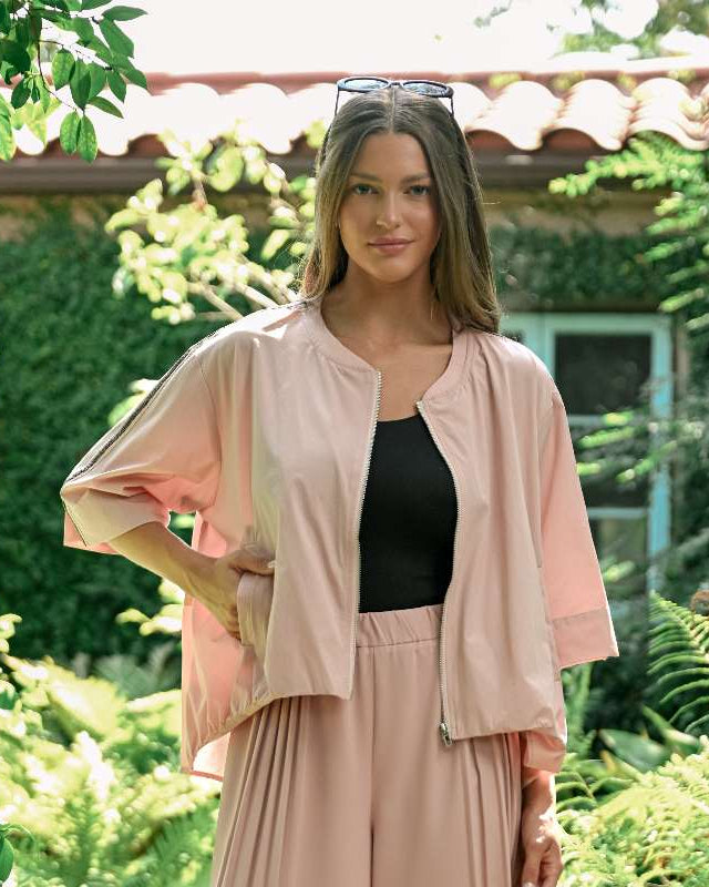 Jolie Top in blush woven parachute fabric with relaxed fit, wide sleeves, and zipper closure