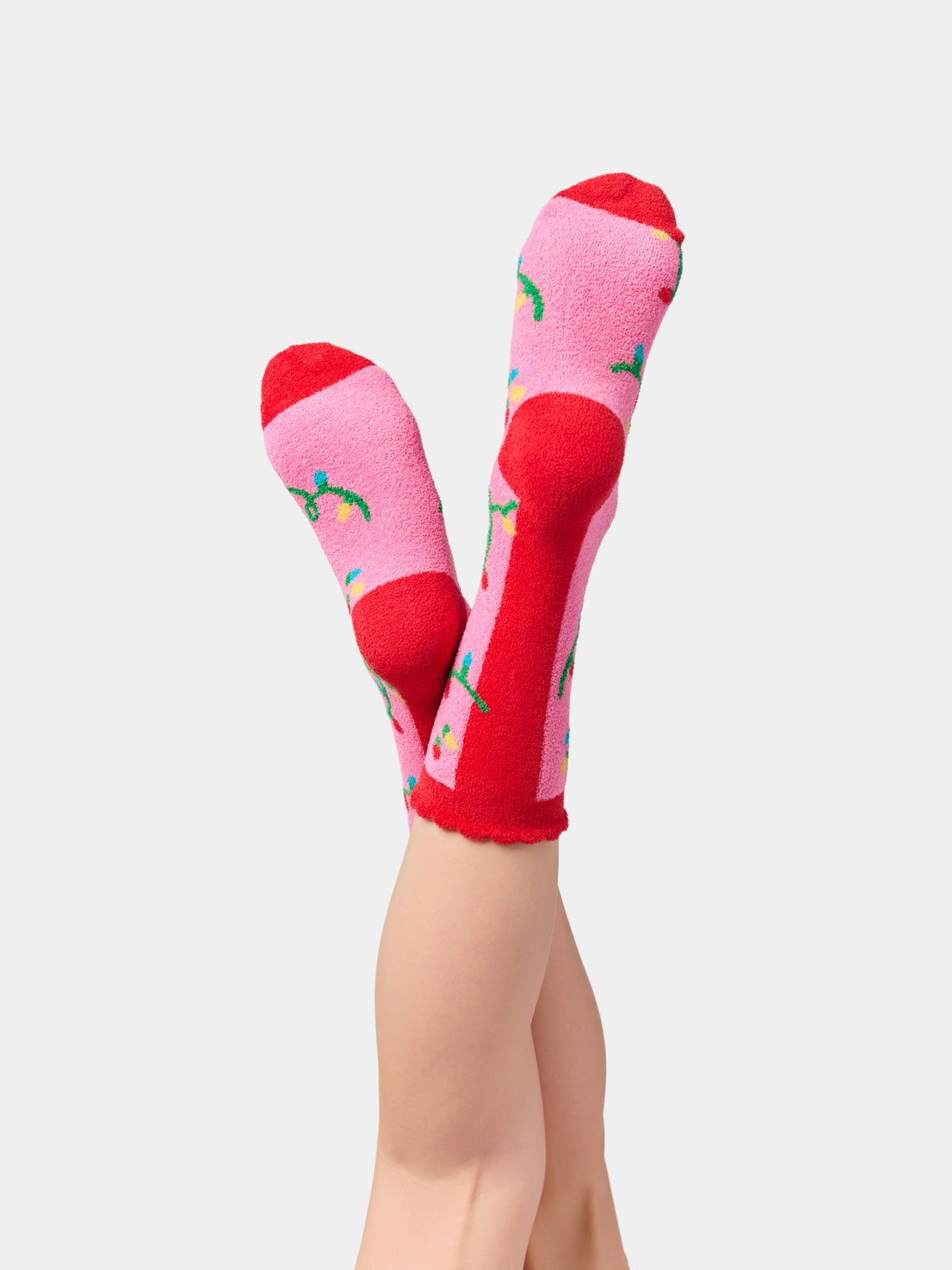 String Lights Socks with pink base, red accents, and green geometric pattern by SHIRALEAH at HCO
