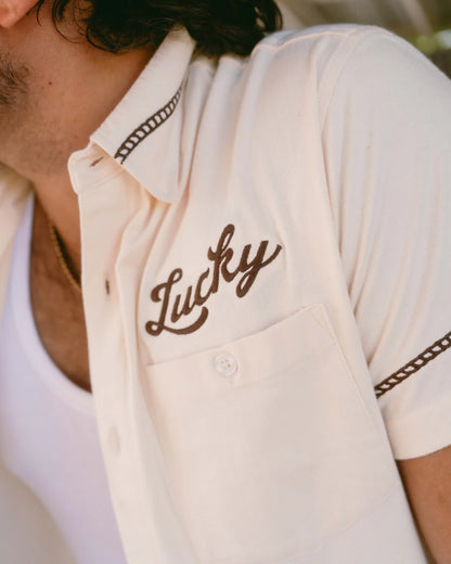 Drifter Shirt - Luck Is Earned beige short sleeve with brown "Lucky" embroidery by TEXAS STANDARD