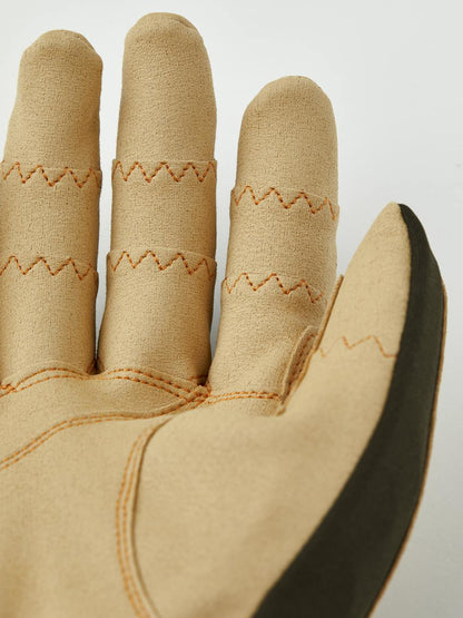 Close-up of tan and dark green fabric glove showcasing detailed zigzag stitching, designed for comfort and durability in the Ergo Grip Tactility Dk Forest.