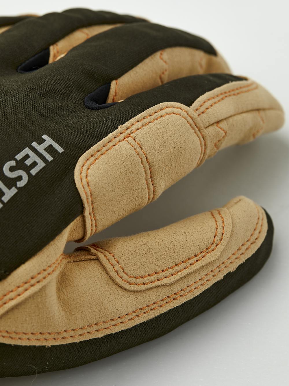 Close-up of beige and dark green outdoor gloves showcasing durable stitching and padded finger protection, featuring the Ergo Grip Tactility Dk Forest design.