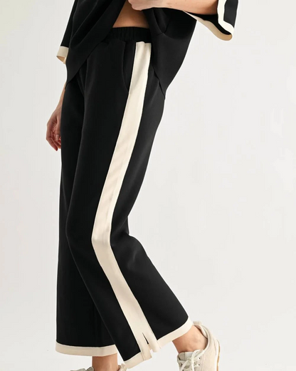 Kristopher Pant - Black by JOH APPAREL, wide-leg black pants with cream side stripes