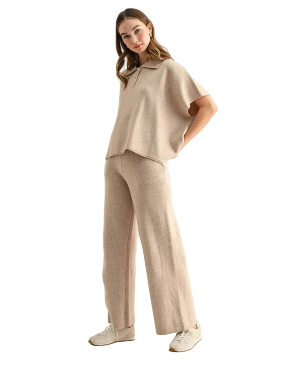 Woman wearing a beige short sleeve top and wide leg pants with sneakers
