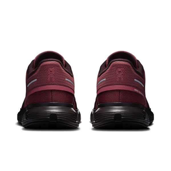 Pair of burgundy and black athletic shoes shown from the rear