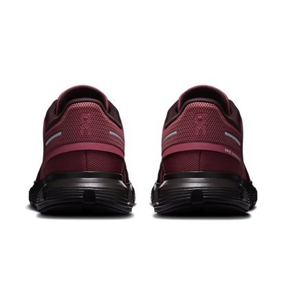 Pair of burgundy and black athletic shoes shown from the rear