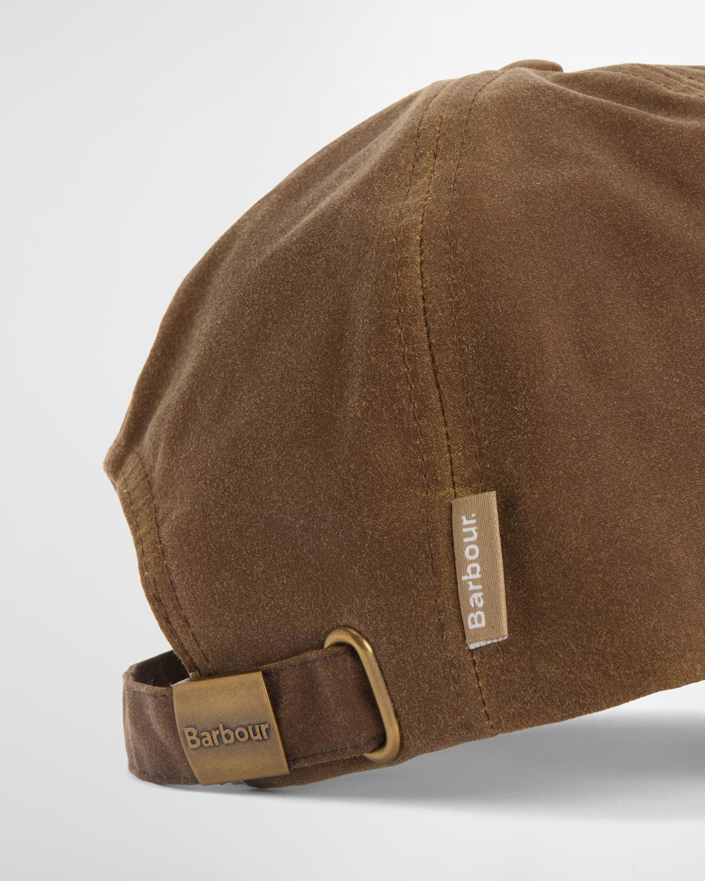 Wax Cap in brown waxed cotton with adjustable strap and subtle Barbour branding, curated Fredericksburg TX