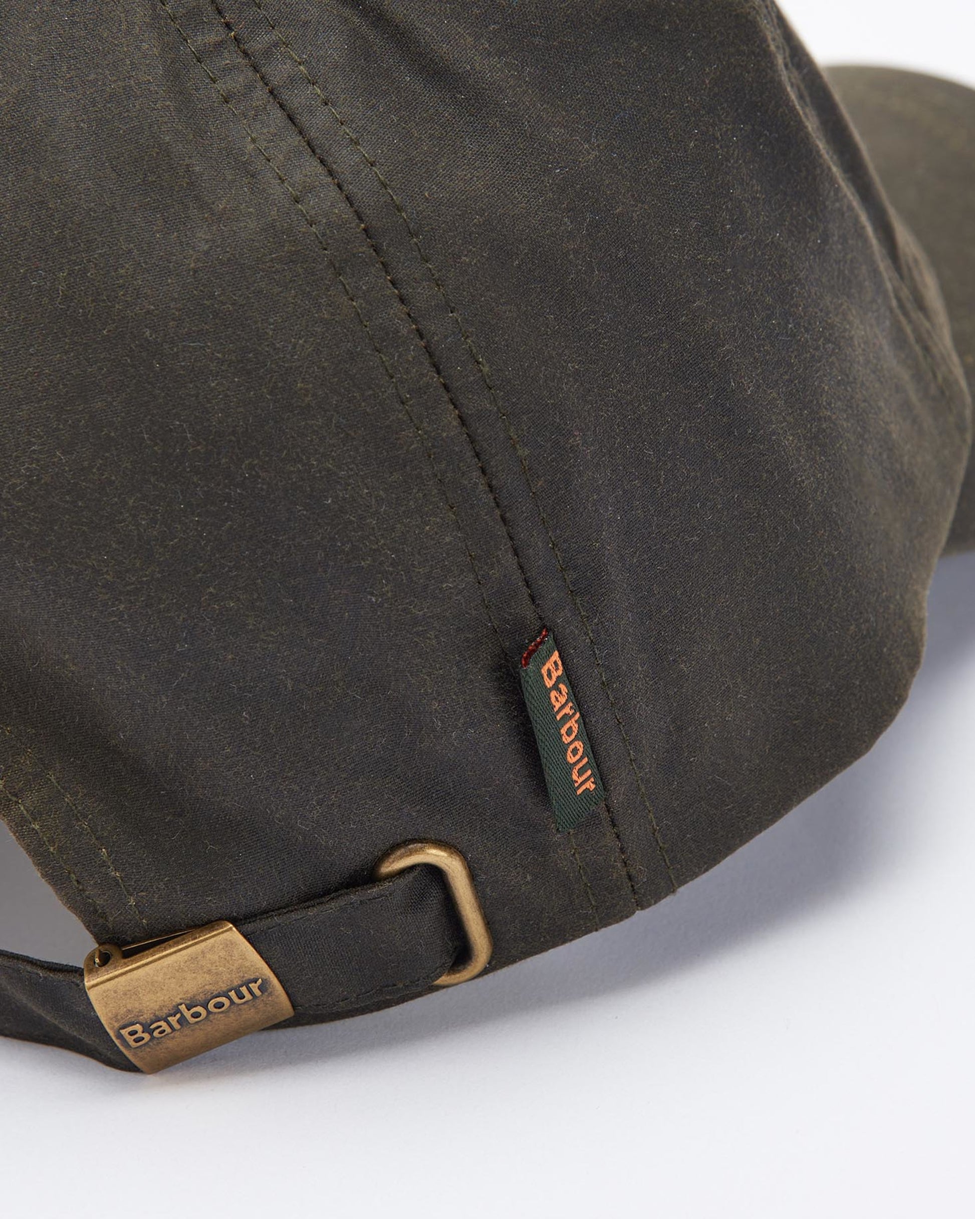 Wax Cap in olive waxed cotton with adjustable strap and Barbour branding, curated Fredericksburg TX