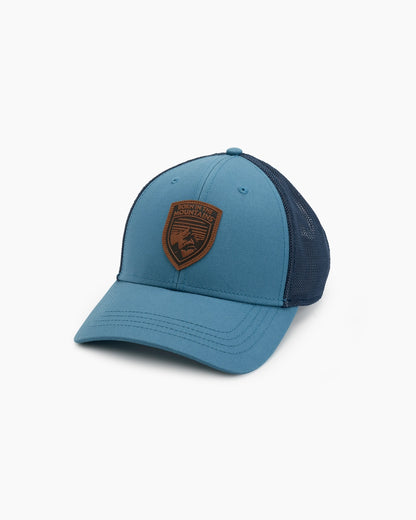 Rustik Born Trucker - Alpine Lake with navy stretch mesh back and custom woven patch, curated Fredericksburg Texas