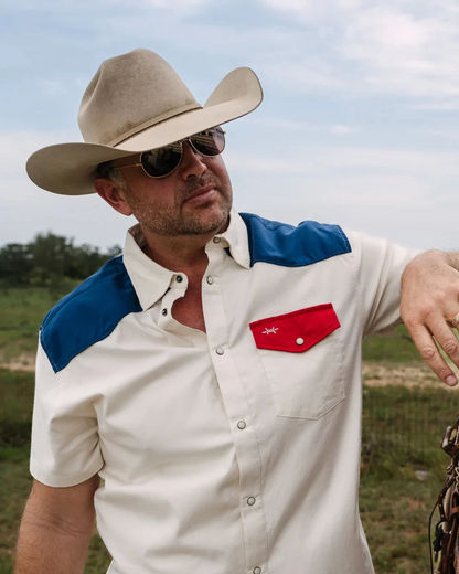 White short-sleeve pearl snap western shirt with blue yoke and red chest pocket