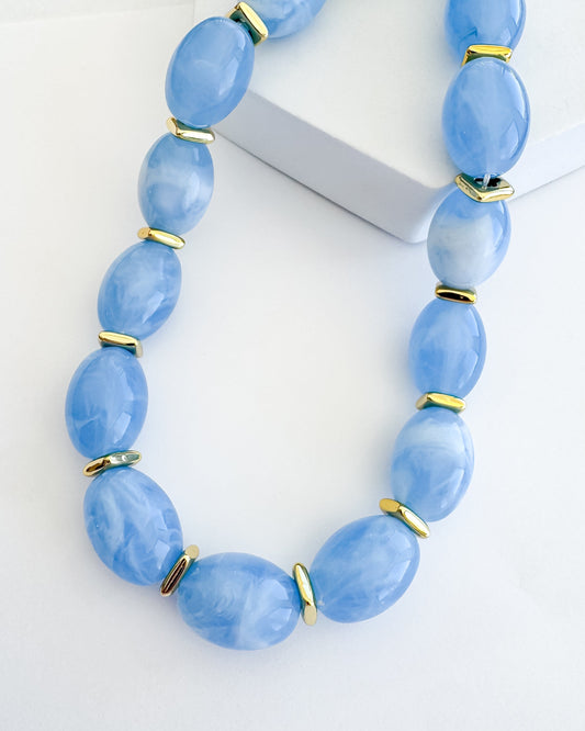 Jelly Pop Blue necklace with smooth sky-blue beads and gold accents, curated in Fredericksburg TX
