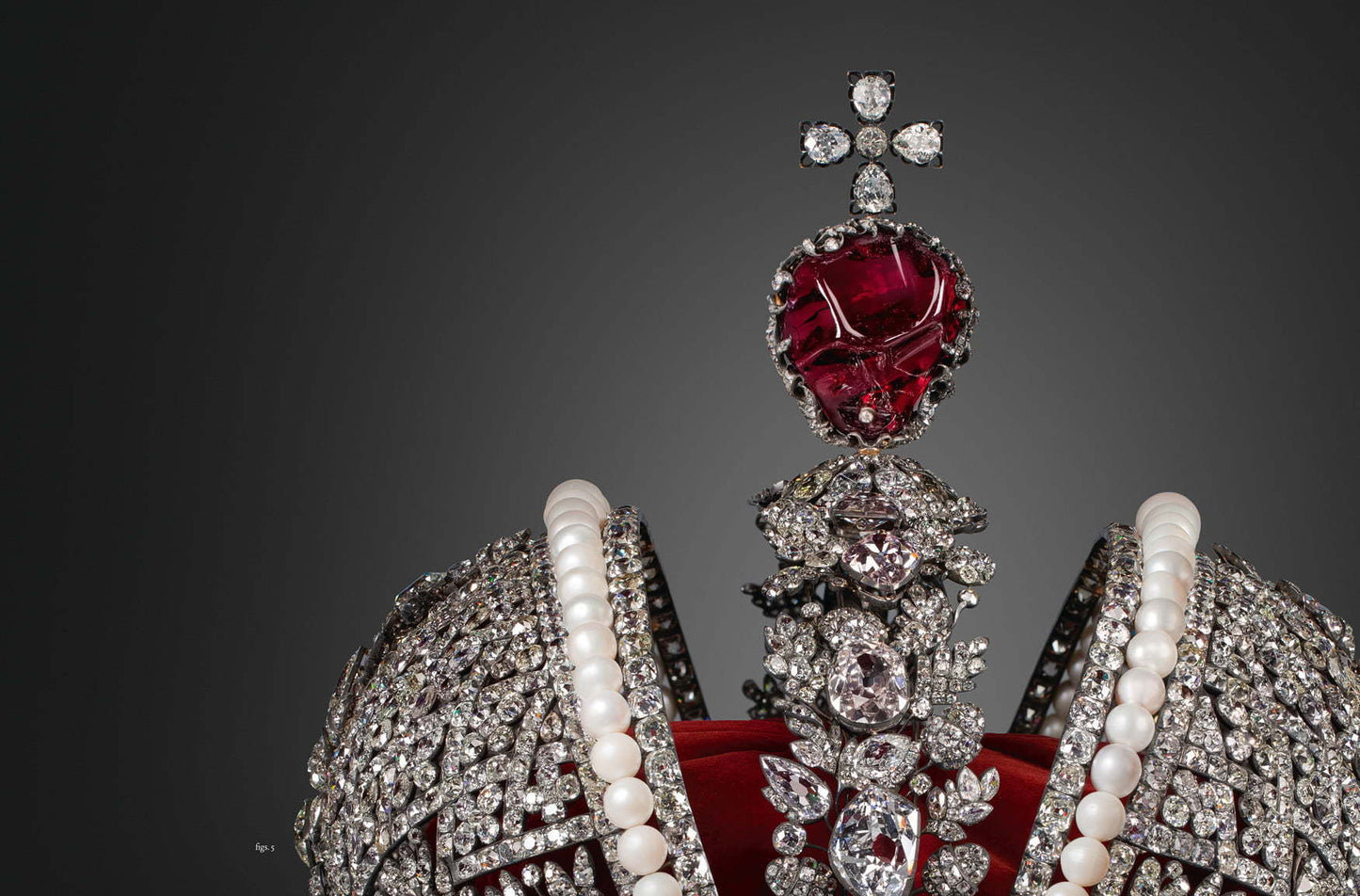 Close-up of an ornate jeweled crown featuring large red gemstones, pearls, and clear sparkling diamonds, showcasing craftsmanship in Diamonds Across Time: Facets Of Mankind.