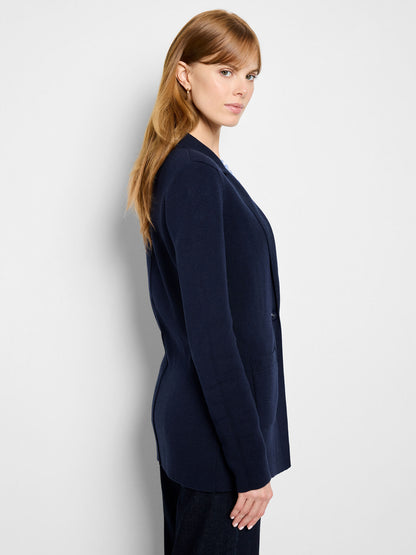 Dark indigo knit blazer, side profile with smooth drape and long sleeves