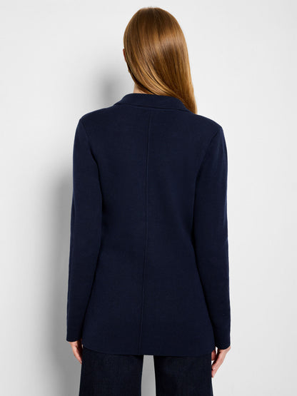 Back view of dark indigo knit blazer with center seam and long sleeves