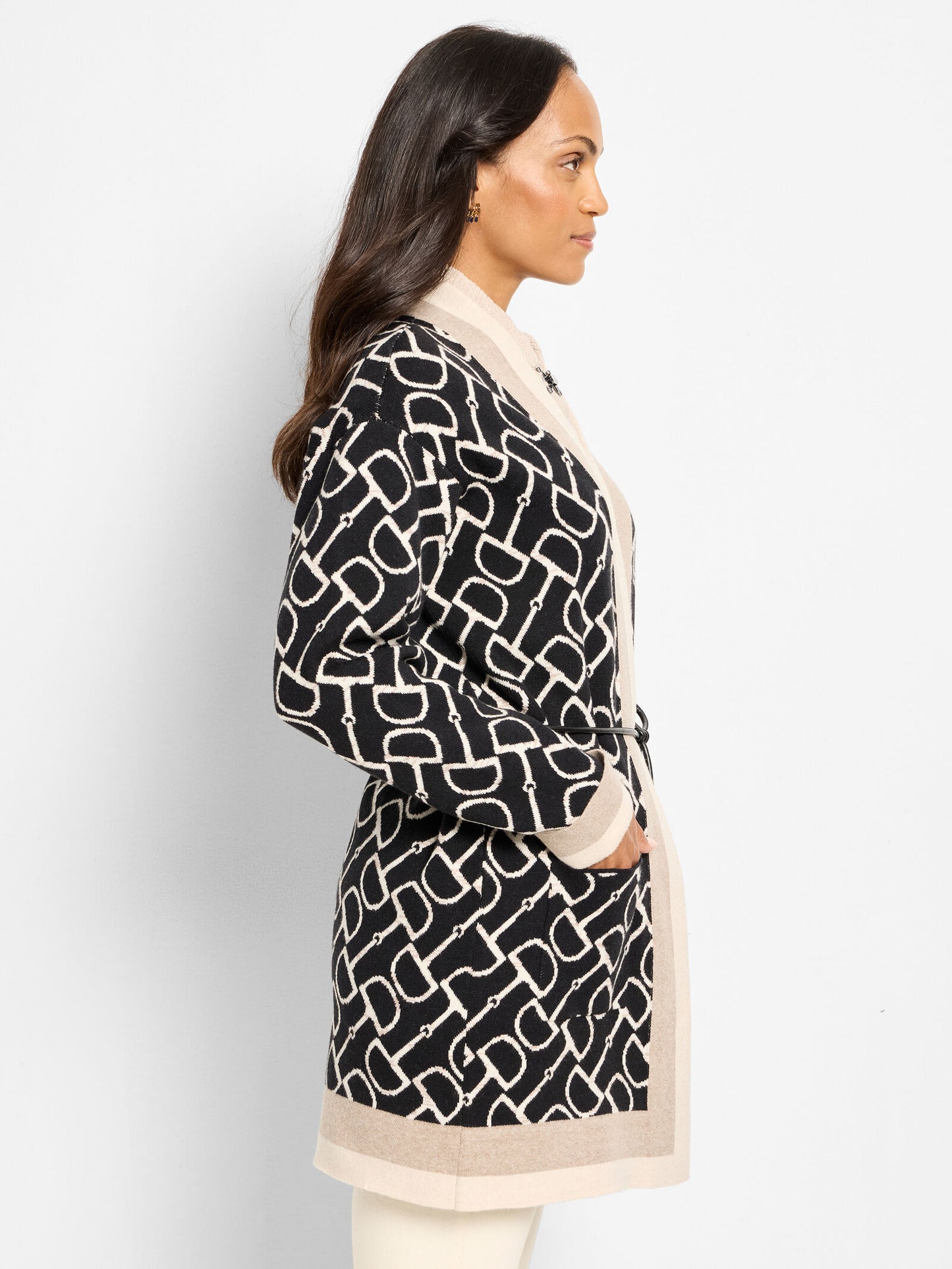 Side view of belted equestrian jacket, black linked print with beige trim