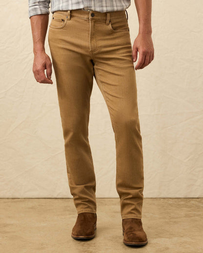 Man wearing tan jeans and brown boots