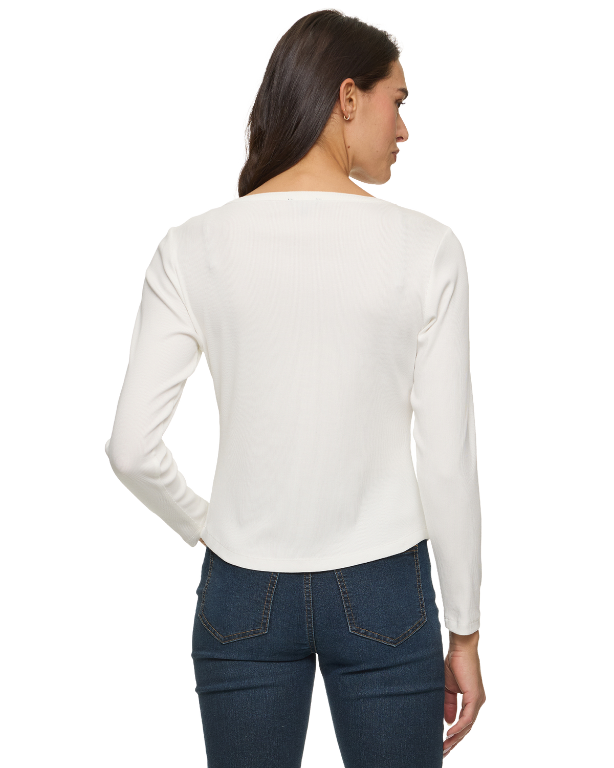 Woman seen from behind wearing a white long-sleeve top and dark blue jeans