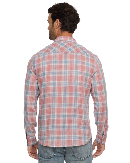Man wearing a red and blue plaid button-up shirt, seen from behind