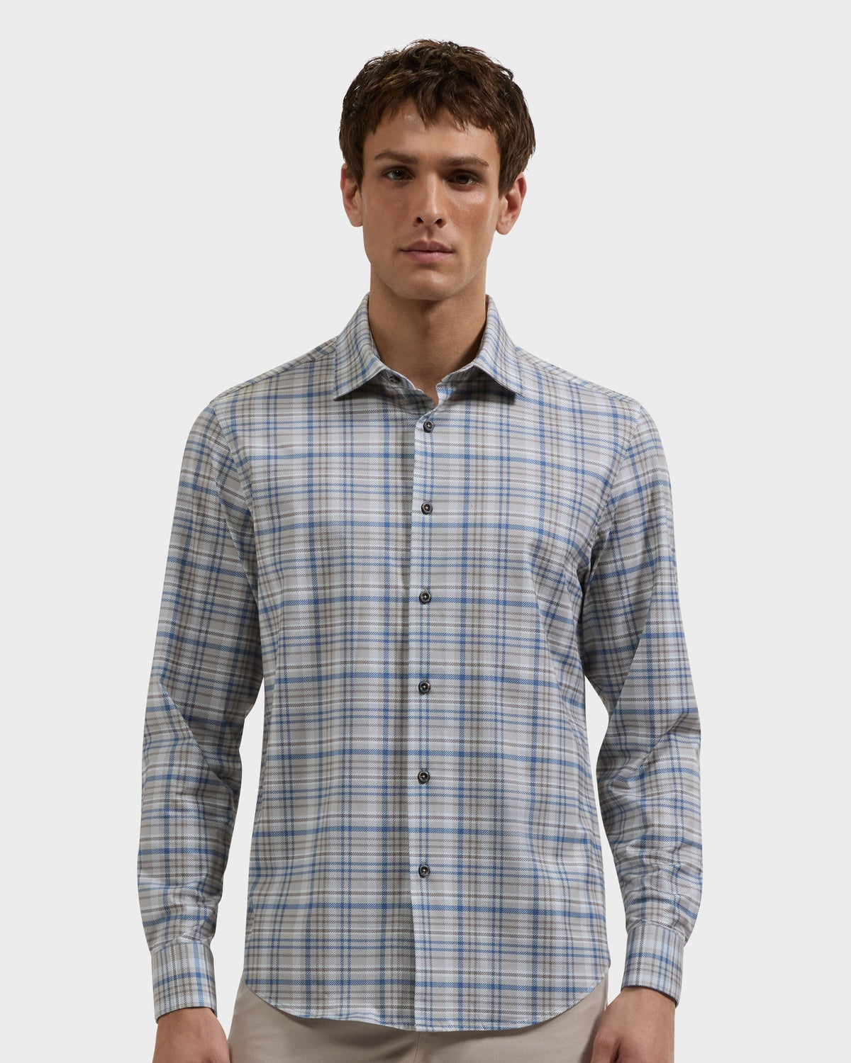 Man wearing a blue and gray plaid button-down shirt
