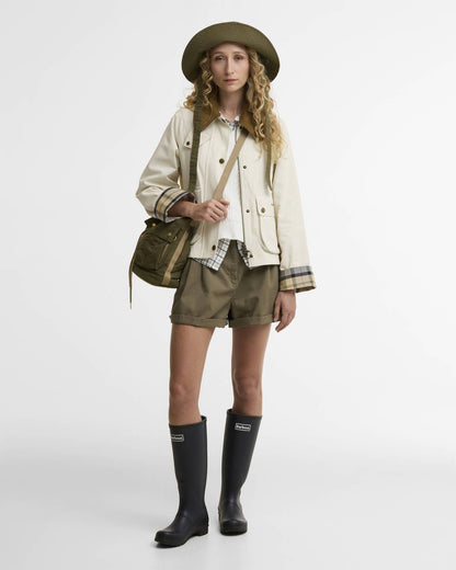 Cropped Beadnell Casual Jacket in beige cotton with tartan cuffs styled with outdoor wear and boots