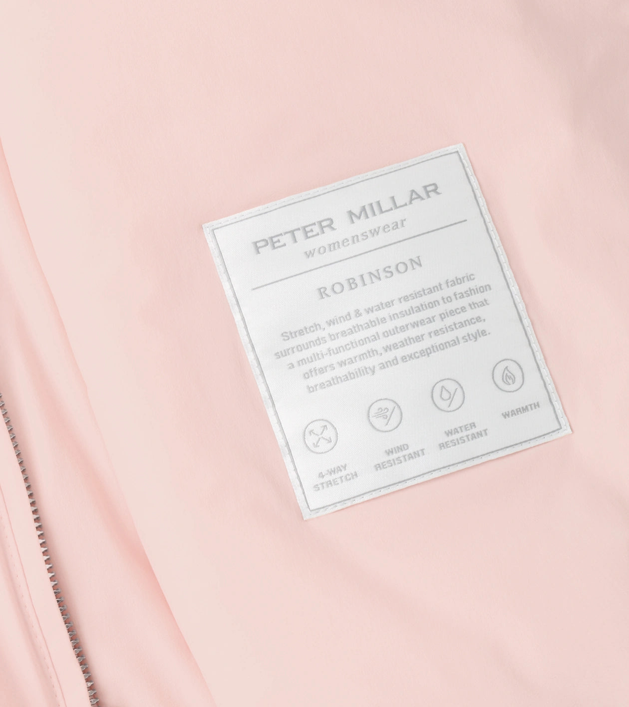 Close-up of Robinson Air Vest label on pink fabric highlighting stretch and weather resistance