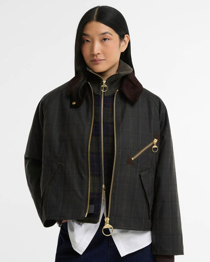 Woman wearing a black plaid jacket with gold zippers and a burgundy collar