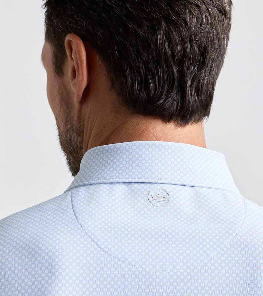 Grant Performance Mesh Polo in light blue with subtle geometric pattern and breathable stretch fabric
